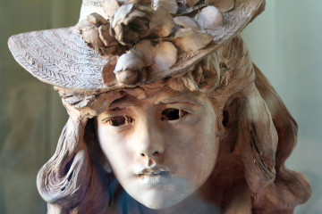 A young girl with flowers in her hat (Rodin)